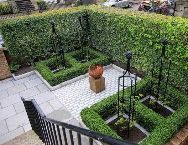 Four Classic Garden Elements garden obelisks in a formal patio garden