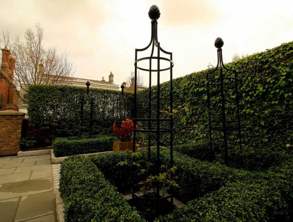 Metal Garden Obelisk I in a patio setting