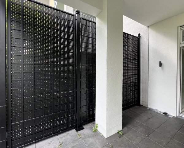 The Gropius Iron Railing Privacy Screen by Classic Garden Elements demarcating the edge of a terrace