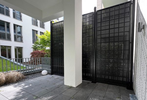 The Gropius Iron Railing Privacy Screen by Classic Garden Elements installed on a balcony