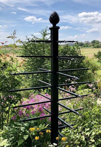 The Geneva Garden Obelisk by Classic Garden Elements on a sunny day