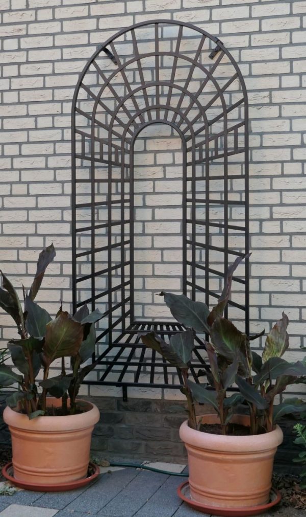 Trompe-l’œil Perspective Trellis Panels by Classic Garden Elements installed on a brick wall