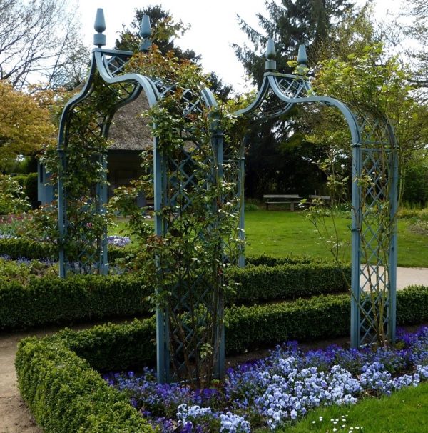 Two blue Brighton Victorian Rose Arches by Classic Garden Elements, in the Blue Garden at Ellerhoop Arboretum in springtime