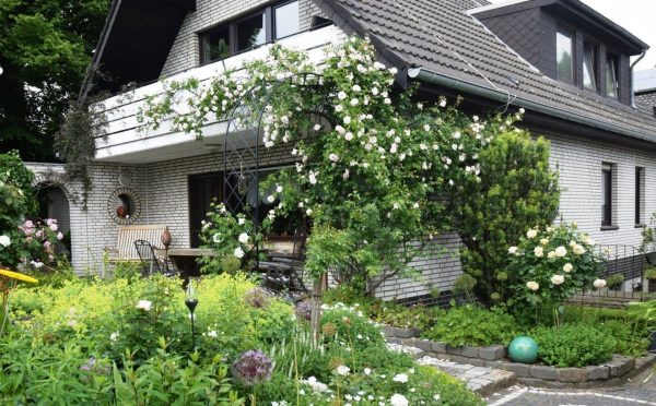 The Half-Round Garden Arch Bagatelle by Classic Garden Elements covered in white roses