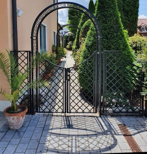 Front view of the Portofino Garden Arch with Gate and Fence in a classic Tuscan garden