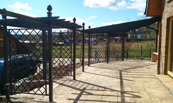 The Piemont Metal Pergola by Classic Garden Elements, custom-made with side trellis panels