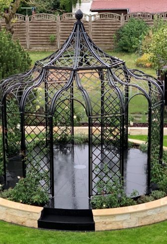 The Schoenbrunn Wrought-Iron Gazebo by Classic Garden Elements with English roses