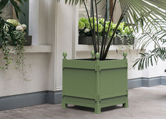 A Caisse de Versailles Planter by Classic Garden Elements in front of a white house wall