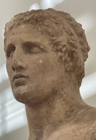 Delphic Statue of Agias – Close-up view of the head with idealized features and short curly hair