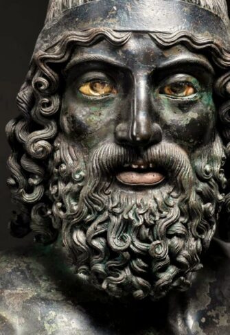 A captivating close-up of the Riace Warrior A’s face, revealing intricate details and lifelike expression. This masterful bronze sculpture embodies the spirit of ancient Greek excellence, perfect for collectors seeking unparalleled artistry